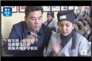 Uyghur children wear traditional Han Chinese-style clothing during a Chinese culture promotion campaign at a Mandarin-language school in Uchturpan County, Xinjiang. The image appeared in a Xinhua report in September 2019.
